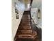 Grand wooden staircase with ornate railing at 1203 W 8Th St, Anderson, IN 46016