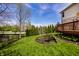 Expansive backyard featuring lush lawn, garden beds, and a wooden deck, perfect for outdoor relaxation at 12596 Autumn Gate Way, Carmel, IN 46033