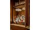 A stylish, well-stocked bar with custom wood cabinets and granite countertops, perfect for entertaining guests at 12596 Autumn Gate Way, Carmel, IN 46033
