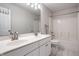 Bright bathroom featuring dual sinks, white cabinets, large mirror, and a tub with shower at 12596 Autumn Gate Way, Carmel, IN 46033