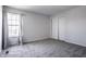 Neutral bedroom featuring plush carpeting, large window for natural light, and closet with sliding doors at 12596 Autumn Gate Way, Carmel, IN 46033