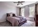 Cozy bedroom with plush carpet, neutral walls, two windows, and a ceiling fan for comfort at 12596 Autumn Gate Way, Carmel, IN 46033
