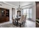 Elegant dining room featuring a stylish table set, complemented by a chandelier and built-in cabinet at 12596 Autumn Gate Way, Carmel, IN 46033