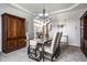 Elegant dining room featuring a stylish table set, complemented by a chandelier and built-in cabinet at 12596 Autumn Gate Way, Carmel, IN 46033