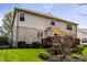 Well-maintained two-story home with a brick and vinyl exterior, a wooden deck, and a beautifully landscaped yard at 12596 Autumn Gate Way, Carmel, IN 46033