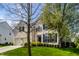 Attractive two-story brick home featuring a manicured lawn, lovely shrubbery and trees on a sunny day at 12596 Autumn Gate Way, Carmel, IN 46033
