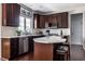 Kitchen featuring white quartz countertops, a dark cabinet island, and stainless steel appliances at 12596 Autumn Gate Way, Carmel, IN 46033