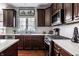 Well-lit kitchen with stainless steel appliances, light countertops, and wood cabinetry at 12596 Autumn Gate Way, Carmel, IN 46033