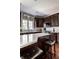 Stylish kitchen with dark cabinets, an island with seating, and stainless steel appliances at 12596 Autumn Gate Way, Carmel, IN 46033