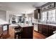 Open-concept kitchen featuring an island with seating and adjacent living area at 12596 Autumn Gate Way, Carmel, IN 46033
