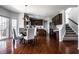 Open floor plan featuring a dark kitchen cabinet, island and hardwood floors at 12596 Autumn Gate Way, Carmel, IN 46033