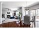 Open-concept living room and dining area with a fireplace and sliding glass doors to the backyard at 12596 Autumn Gate Way, Carmel, IN 46033