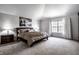 Spacious main bedroom with a king bed, side tables, and a bright window with elegant curtains at 12596 Autumn Gate Way, Carmel, IN 46033