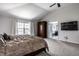 Cozy main bedroom featuring a comfortable bed, a wardrobe, and an adjoining bathroom with tub at 12596 Autumn Gate Way, Carmel, IN 46033
