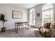 Bright home office space with a wooden desk, comfortable seating, and sunlit arched windows at 12596 Autumn Gate Way, Carmel, IN 46033