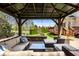A pergola and outdoor seating overlooking the landscaped backyard at 12596 Autumn Gate Way, Carmel, IN 46033
