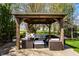 Stylish outdoor pergola with comfortable seating, ideal for relaxing and entertaining in the backyard at 12596 Autumn Gate Way, Carmel, IN 46033