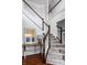 Staircase with white and wood banister, art, a table, and a lamp at 12596 Autumn Gate Way, Carmel, IN 46033