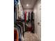 Carpeted walk-in closet featuring wire shelving, ample hanging space, and storage for organization at 12596 Autumn Gate Way, Carmel, IN 46033