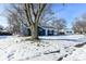 Blue house exterior, winter view with large tree at 1305 Woodbine Dr, Anderson, IN 46011