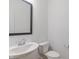 Small bathroom with pedestal sink, toilet, and framed mirror at 13359 Vickery Ridge Dr, Fishers, IN 46037
