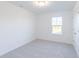 Spacious bedroom with window, neutral walls and carpet, and double doors at 13359 Vickery Ridge Dr, Fishers, IN 46037