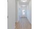 Light and bright hallway with hardwood floors and white doors at 13359 Vickery Ridge Dr, Fishers, IN 46037