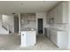 Bright kitchen featuring shaker cabinets, quartz countertops, and a spacious island and a staircase at 13359 Vickery Ridge Dr, Fishers, IN 46037