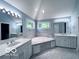 Bathroom with double sinks, large soaking tub and natural light from the picture window at 13650 Golden Ridge Ln, Fishers, IN 46055