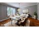 Dining room featuring hardwood floors, neutral paint, a modern light fixture and large window at 13650 Golden Ridge Ln, Fishers, IN 46055