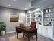 Home office with a desk, chair, carpet, and built-in shelving at 13650 Golden Ridge Ln, Fishers, IN 46055