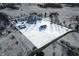 Aerial view of a snowy homestead with home, barn, creek and wooded area surrounded by a white border at 1600 S Morgantown Rd, Morgantown, IN 46160