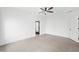 Minimalist bedroom with polished concrete floors, a ceiling fan, and crisp white walls at 1600 S Morgantown Rd, Morgantown, IN 46160