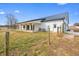 Modern farmhouse exterior with a metal roof, covered porch, and a spacious yard enclosed by a rustic wooden fence at 1600 S Morgantown Rd, Morgantown, IN 46160