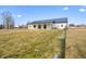 A modern farmhouse exterior with a metal roof and a spacious yard enclosed by a rustic wooden fence at 1600 S Morgantown Rd, Morgantown, IN 46160