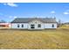 Bright modern farmhouse with a metal roof and inviting entryway is surrounded by a beautifully landscaped yard at 1600 S Morgantown Rd, Morgantown, IN 46160