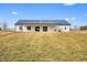 Modern farmhouse with covered porch and side garage on large green lawn at 1600 S Morgantown Rd, Morgantown, IN 46160