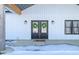 Charming double front doors adorned with wreaths and lantern sconces create a warm and inviting entryway at 1600 S Morgantown Rd, Morgantown, IN 46160