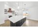 Bright kitchen with a large island, white countertops, stainless steel appliances, and open shelving at 1600 S Morgantown Rd, Morgantown, IN 46160