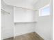 Bright, well-lit walk-in closet with ample hanging space and shelving, complemented by a window at 1600 S Morgantown Rd, Morgantown, IN 46160