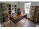 Home office with rustic wooden desk, shelving, and a comfortable chair at 1715 Danielle Rd, Lebanon, IN 46052