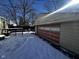 Detached garage with red door, snow-covered ground at 2009 Calhoun St, Indianapolis, IN 46203