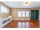 Bright living room with hardwood floors, built-in shelving, and large windows at 202 Noble St, Greenwood, IN 46142