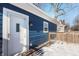 Back exterior showing blue siding, white door and small deck at 2249 N Parker Ave, Indianapolis, IN 46218