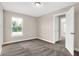 Well-lit bedroom with a window, carpet, and access to other rooms at 250 Ambassador Dr, Pittsboro, IN 46167