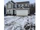 Charming two-story home featuring gray siding, white trim, and an attached two-car garage at 250 Ambassador Dr, Pittsboro, IN 46167