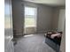 Bedroom with neutral paint, carpet flooring, and natural light coming through the large window at 251 Dyson Dr, Whiteland, IN 46184