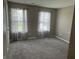 Bright bedroom with neutral walls, carpeted floor, and floral curtains at 251 Dyson Dr, Whiteland, IN 46184