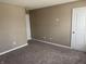 Neutral bedroom with neutral colored walls and carpet and a white door at 251 Dyson Dr, Whiteland, IN 46184