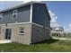 Gray home shows rear brick side elevation and siding at 251 Dyson Dr, Whiteland, IN 46184